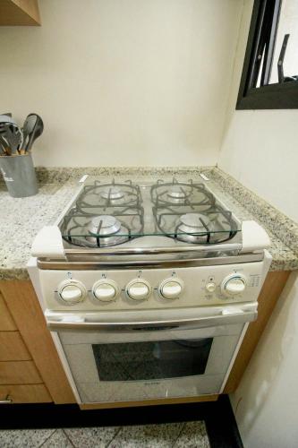 a stove top oven sitting in a kitchen at Apartamento Duplex Place Vendome! Moema, 58m2, Amplo, Conforto, Luxo! Servicos, Estacionamento, Internet, Metro! in Sao Paulo
