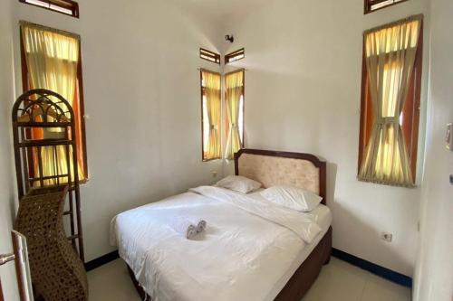 a bedroom with a bed with a stuffed animal on it at Nirwana Lembang in Tangkubanperahu