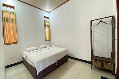 a bedroom with a bed and a tv in it at Nirwana Lembang in Tangkubanperahu
