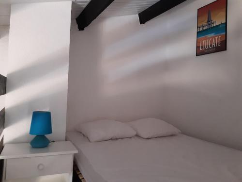 - une chambre blanche avec un lit et une lampe bleue dans l'établissement Moderne T2 Mezzanine - 6 Pers. Près Plage et Port, Parking Privé, 36m², Terrasse - Port Leucate - FR-1-798-7, à Leucate