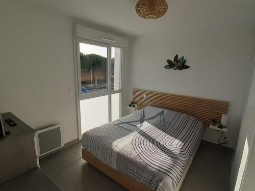une chambre avec un lit et une fenêtre dans l'établissement Superbe T2 climatisé avec parking, 4 pers, proche plage - FR-1-798-23, à Leucate