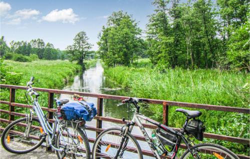 two bikes parked on a bridge next to a river at Holiday Home Barczewo Kaplityny Iv in Barczewo