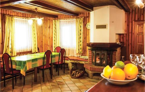 a dining room with a table and a fireplace at Holiday Home Barczewo Kaplityny Iv in Barczewo