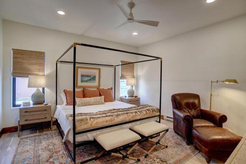 a bedroom with a canopy bed and a chair at BHA - Luxury A-Frame in Creede