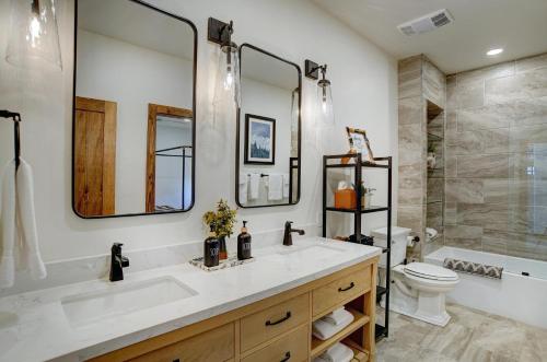 a bathroom with a sink and a toilet and a tub at BHA - Luxury A-Frame in Creede