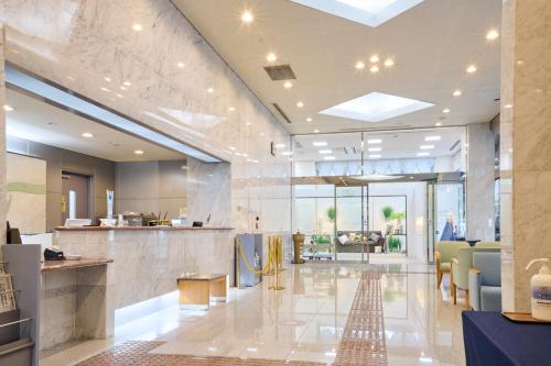 a lobby with a waiting room and a restaurant at Hotel Kumamoto Terrsa in Kumamoto