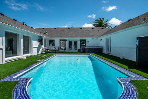 a swimming pool in the backyard of a house at Poolside Opulence Tennis and HotTub in Corpus Christi