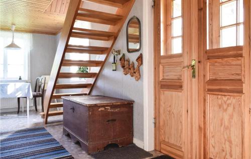 a room with a wooden staircase and a wooden door at Lovely Home In Virserum With Wifi in Virserum