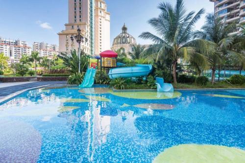 a swimming pool with a slide and a water park at Sanya Baohong Hotel in Sanya