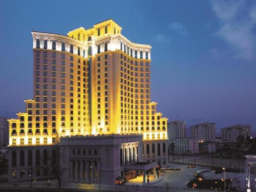 a large building with yellow lights on top of it at Sanya Baohong Hotel in Sanya