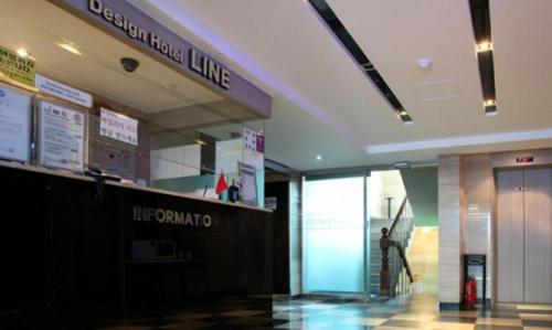 a lobby of a building with a line on the wall at Line Plus Hotel in Gimpo