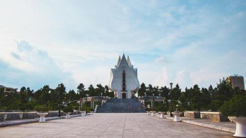 a large white building with a clock tower in the distance at Bacninh Charming Hotel in Bắc Ninh