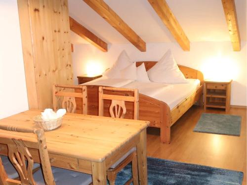 a bedroom with a bed and a table and a table sidx sidx at Ferienwohnungen Stecher in Bad Endorf