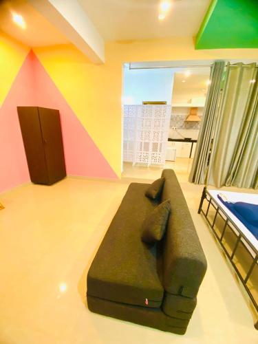 a couch in a room with a colorful wall at Vyana villa by the beach in Morjim