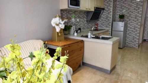 a kitchen with a sink and a counter top at Chaoyang Joy City Hardcover Apartment in Beijing