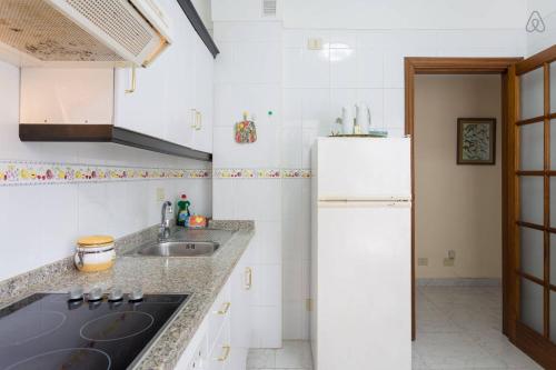 a kitchen with a sink and a refrigerator at Apartamento Maya in Las Lagunas