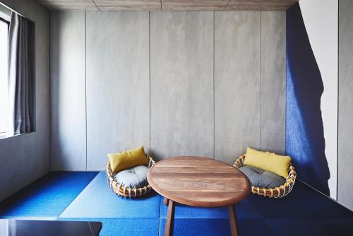 a dining room with a table and two chairs at voco Osaka Central by IHG in Osaka
