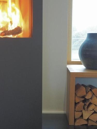 a vase sitting on a table next to a window at Exklusives Ferienhaus in Huppenbroich mit Terrasse, Grill und Garten in Simmerath