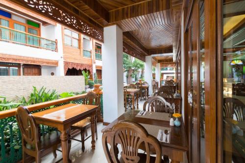 a restaurant with a table and chairs on a patio at Pingviman Hotel in Chiang Mai