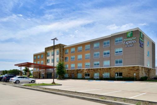 an office building with a car parked in a parking lot at Holiday Inn Express & Suites - Wylie West by IHG in Wylie