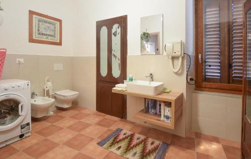a bathroom with a sink and a washing machine at Nice Apartment In Castilenti With Wifi in Castilenti
