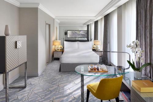 a hotel room with a bed and a table at Mandarin Oriental, Geneva in Geneva