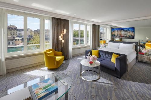 a hotel room with a bed and a couch and a table at Mandarin Oriental, Geneva in Geneva