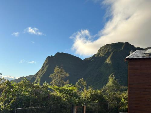 a view of a mountain range with a house at Chalet Mon Plaisir in La Plaine des Palmistes