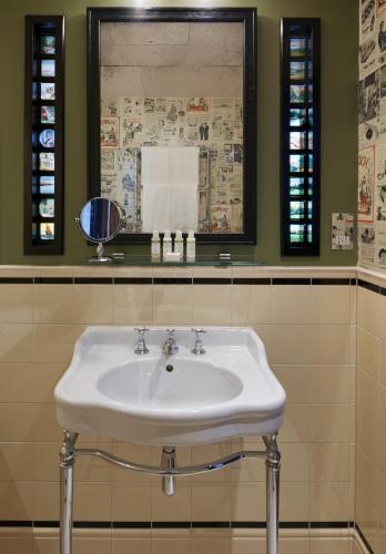 a white sink in a bathroom with a mirror at The Zetter Marylebone in London