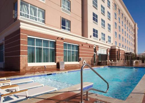 a swimming pool in front of a building at Holiday Inn Dallas - Fort Worth Airport South by IHG in Euless