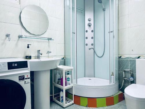 a bathroom with a shower and a sink and a toilet at Urban Suites Spacious 2-Bedroom Apartment in Taryaatayn Baraanii Bayshing