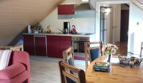 a kitchen and dining room with a wooden table at Ferienwohnung mit herrlichem Moselblick in Piesport