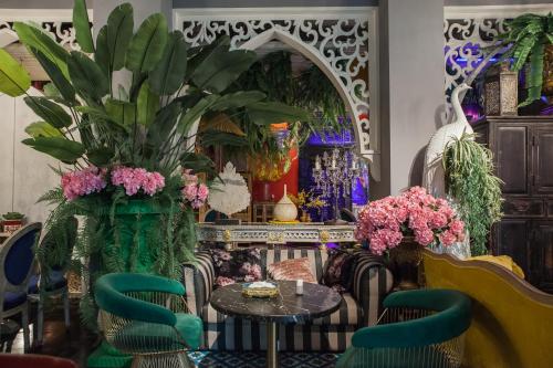 a room with chairs and a table with flowers at Anna King Hotel in Chiayi City