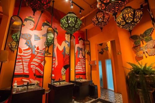 a bathroom with two sinks and two mirrors at Anna King Hotel in Chiayi City