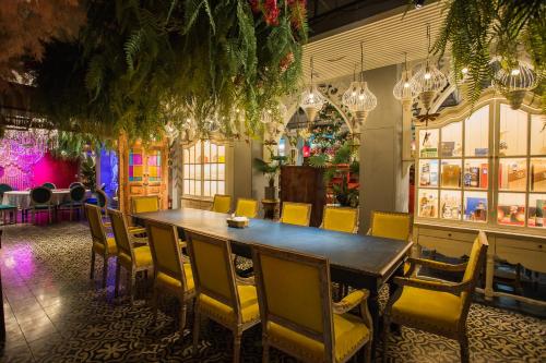 a dining room with a table and yellow chairs at Anna King Hotel in Chiayi City