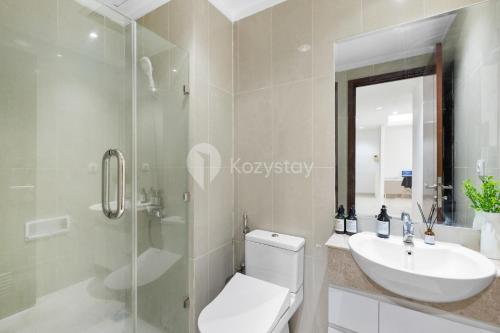 a bathroom with a toilet and a sink and a shower at Sattva by Kozystay - Kuningan in Jakarta