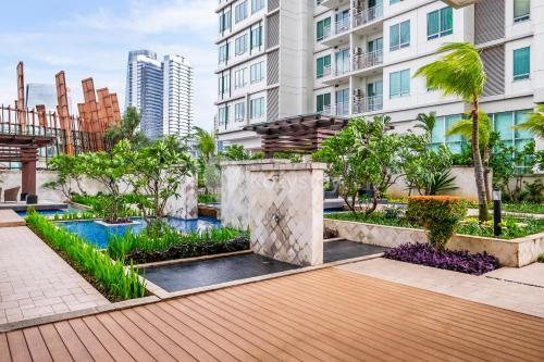 a courtyard with a pool in a building at Sattva by Kozystay - Kuningan in Jakarta