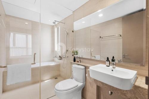 a bathroom with a white toilet and a sink at Neira by Kozystay - PIK in Jakarta