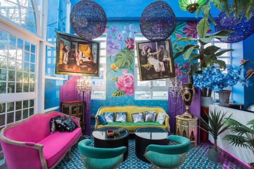 a room with colorful furniture and paintings on the wall at Anna King Hotel in Chiayi City