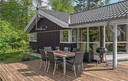 a patio with a table and chairs on a deck at Beautiful Home In Græsted With Wifi in Græsted