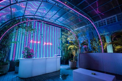a room with a bunch of plants and purple lights at Anna King Hotel in Chiayi City