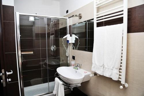 a bathroom with a sink and a shower at Hotel Miramonti in Gangi