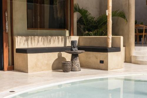 a swimming pool with two vases next to a fountain at Karma Resort in Bophut 