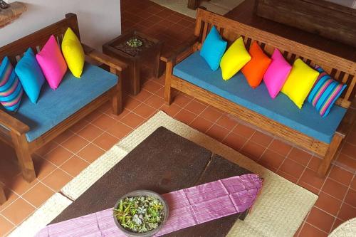 an overhead view of two benches with colorful pillows at Casa MORELOS Morelia Mich Centro historico in Morelia