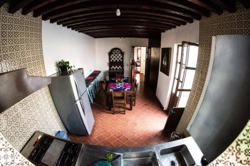 a view of a kitchen and a living room with a table at Casa MORELOS Morelia Mich Centro historico in Morelia