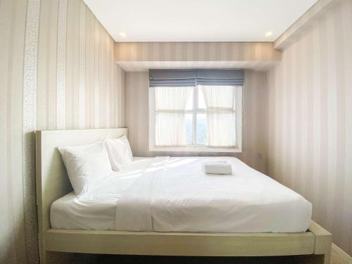 Ένα ή περισσότερα κρεβάτια σε δωμάτιο στο Homey Apartment with 1BR at Parahyangan Residence By Travelio