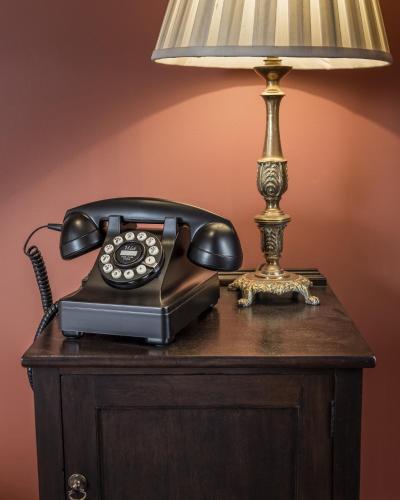 a telephone and a lamp on a table at The Zetter Marylebone in London