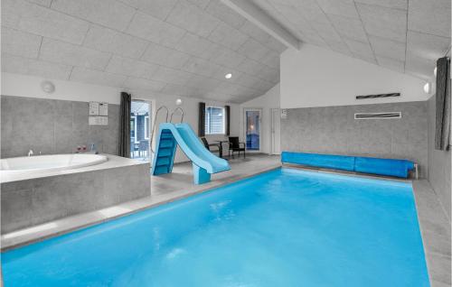 a large pool with a slide in a bathroom at 8 Bedroom Stunning Home In Nordborg in Nordborg