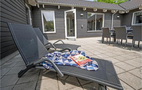 a chair on a patio with a blanket on it at 8 Bedroom Stunning Home In Nordborg in Nordborg