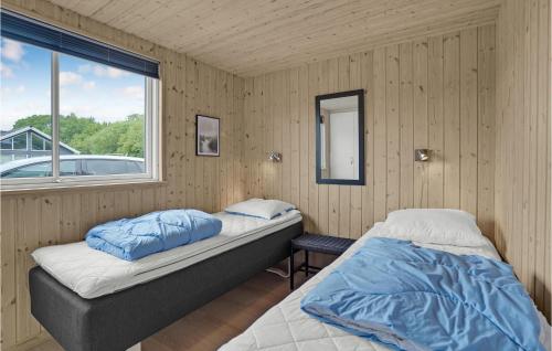 a bedroom with two beds and a window at 8 Bedroom Stunning Home In Nordborg in Nordborg